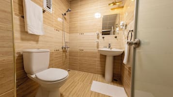 Family Quadruple Room, Courtyard View | Bathroom | Shower, hair dryer, slippers, towels