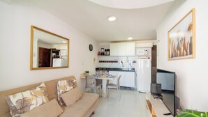 A compact living space with a sofa, dining table, and kitchenette. - Apt in Condo w/ Pool 110m From the Beach Vem0306 (João Pessoa)