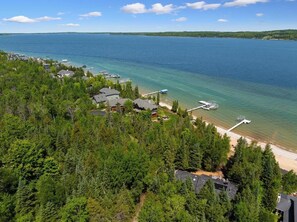 A coastal area with houses, a beach, and a dock. - Summer Here!  Ski In/Out at base of the Disciples 8 lift.  Sleeps 16 (Boyne Falls)