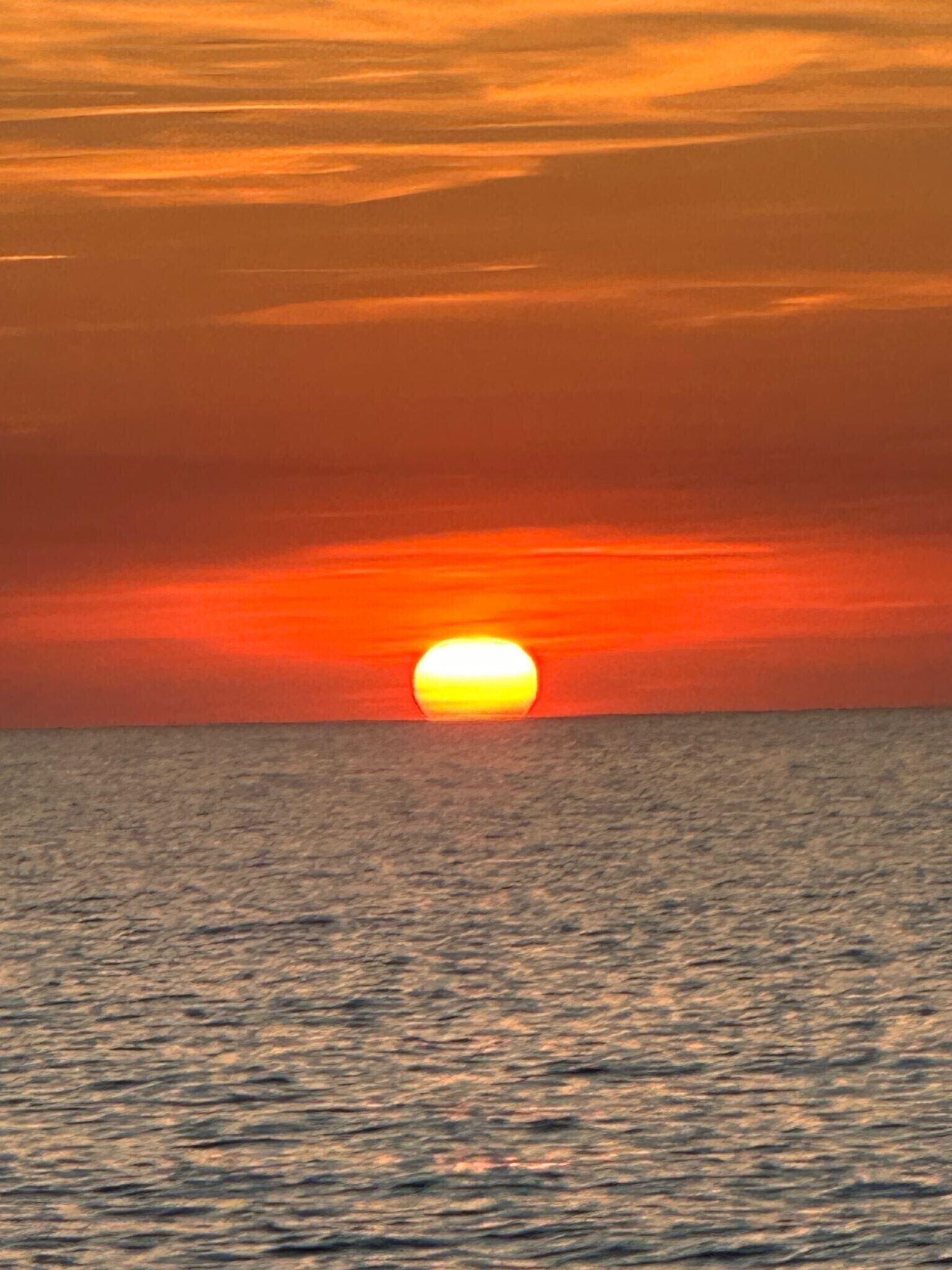 Un atardecer sobre una extensión de agua.