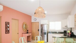 A kitchen with a refrigerator, a clock, and a dining area with chairs. - Chic Desert Escape in Baja Sur Desierto!
Rooftop pool with stunning sea view (Cabo San Lucas)