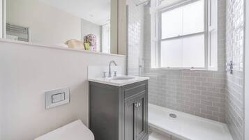 Shower, hair dryer, towels, shampoo
