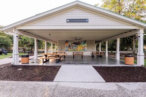 A covered pavilion with picnic tables and a mural on the wall. - Dogs Welcome! Adorable 3-bedroom Coastal Home in Historic Old Town Bluffton (Bluffton)