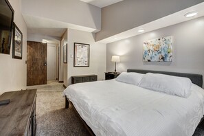 A bedroom with a large bed, a desk, a nightstand, a lamp, and a framed picture on the wall. - Beautiful 2BR/2BA condo in Keystone, offering a tranquil mountain retreat (Keystone)