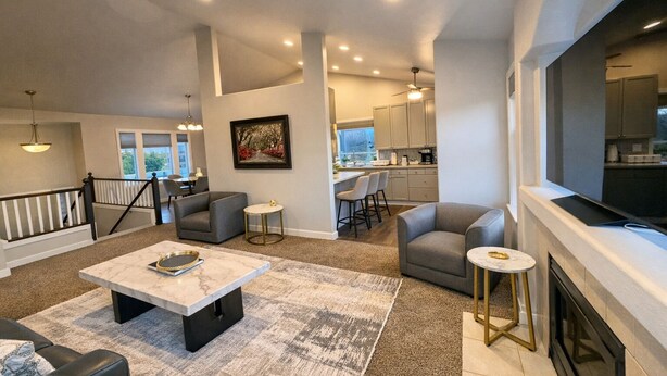 A spacious living room with a fireplace, a dining area, and a kitchen in the background. - Entire Upper Level Home w/Fast Wi-Fi •20 Min SEA, Parking (Kent)