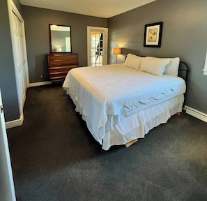 A bedroom with a bed, dresser, mirror, and a framed picture on the wall. - Stay in a beautiful farmhouse on a Apple Orchard (Williamsburg)