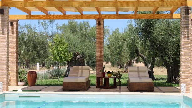 A pool area with two lounge chairs, a brick pillar, and a pergola overhead. - Gravanis Resort Luxury Villa with Private Pool in 30Acre Olive Grove near Athens (Sykamino)