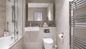 A modern bathroom with a glass-enclosed shower, a white sink, a toilet, and a towel rack. - Kings Cross Apt W/ Balconies | st pancras & camden (London)