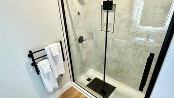 Shower, hair dryer, towels, shampoo