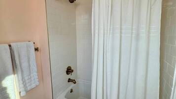 Shower, hair dryer, towels, shampoo