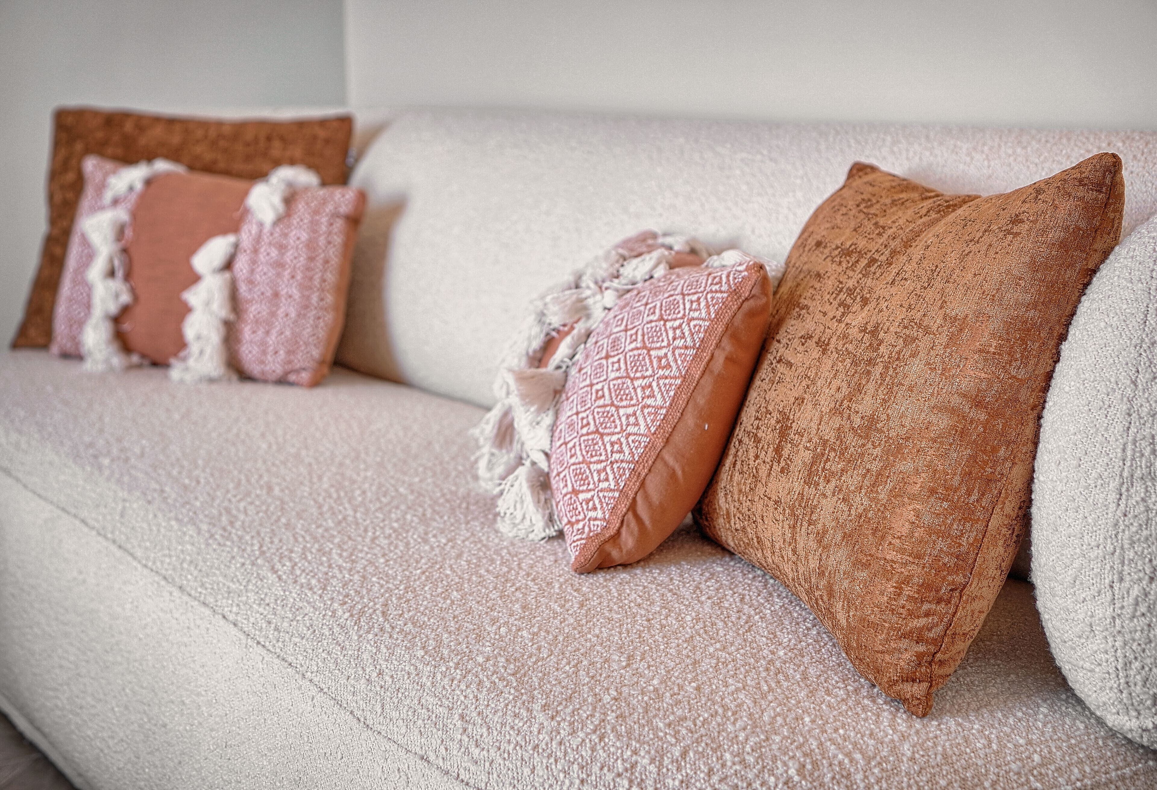 A sofa with three pillows.
