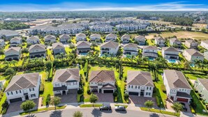 A residential area with modern houses, a central swimming pool, and well-maintained lawns.