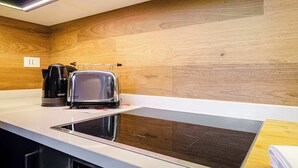 Eine moderne Küche mit Einbauherd, Kaffeemaschine und Toaster.