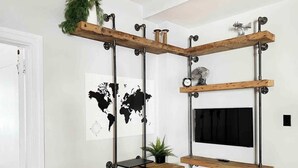 A room with a desk, a world map, a clock, and a plant. - FIFA Walkable King Bed 3 Beds (Philadelphia)