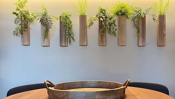 A round wooden table with a metal tray in the center, surrounded by chairs. - Historic | Parking | Walk Score 98 | Cozy (Philadelphia)