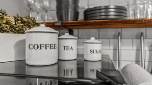 A kitchen counter with labeled storage jars for coffee, tea, sugar, and lemon. - Huge Desk - Central - Soak Tub - Walkscore 98 (Philadelphia)