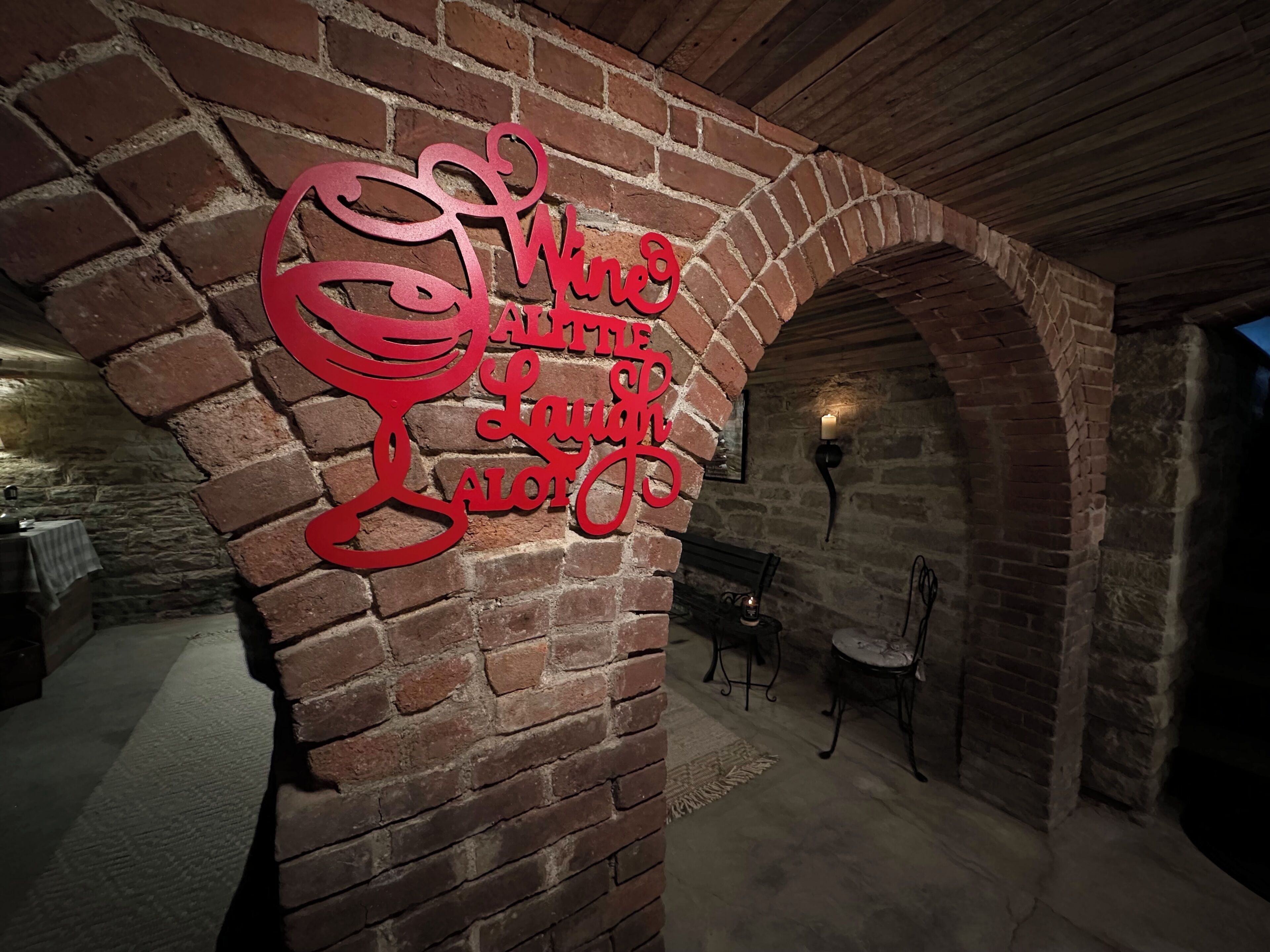 A brick wall with a red sign that reads 'Welcome to Laugh Lot.'
