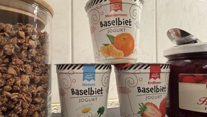 Three containers of Baselibiet yogurt with different flavors and a jar of granola.