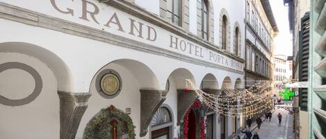 The Grand Hotel Porta Rossa facade with arched windows and a sign above the entrance.