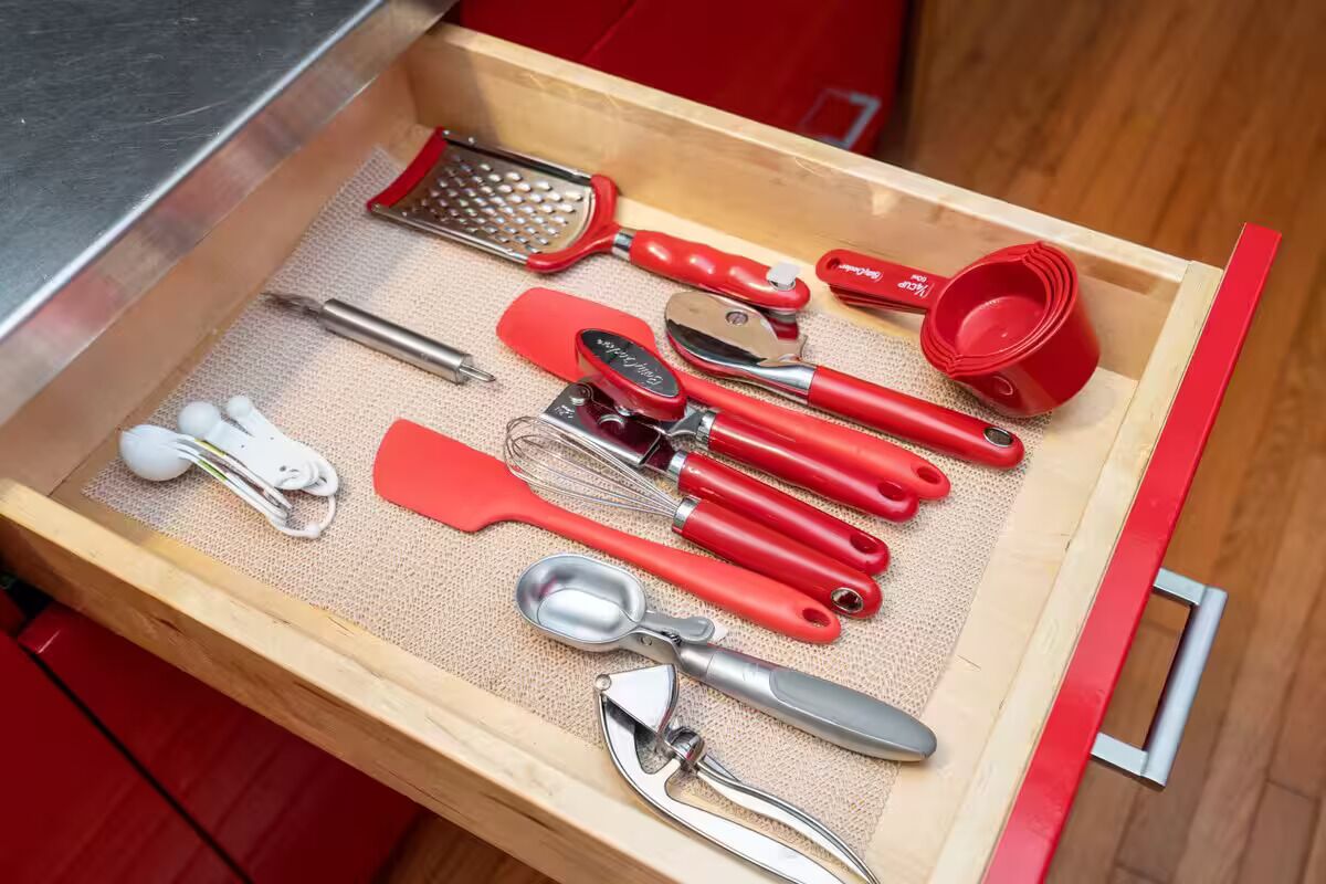 A drawer containing various kitchen utensils.
