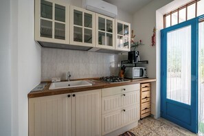 A kitchen with a sink, stove, cabinets, and a microwave. - Torrette di Ostuni – Private Villa with Pool near Ostuni (Ostuni)