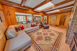 A wooden interior with a sofa, rug, and fireplace. - Dog-Friendly Retreat Near Thumb Butte (Prescott)