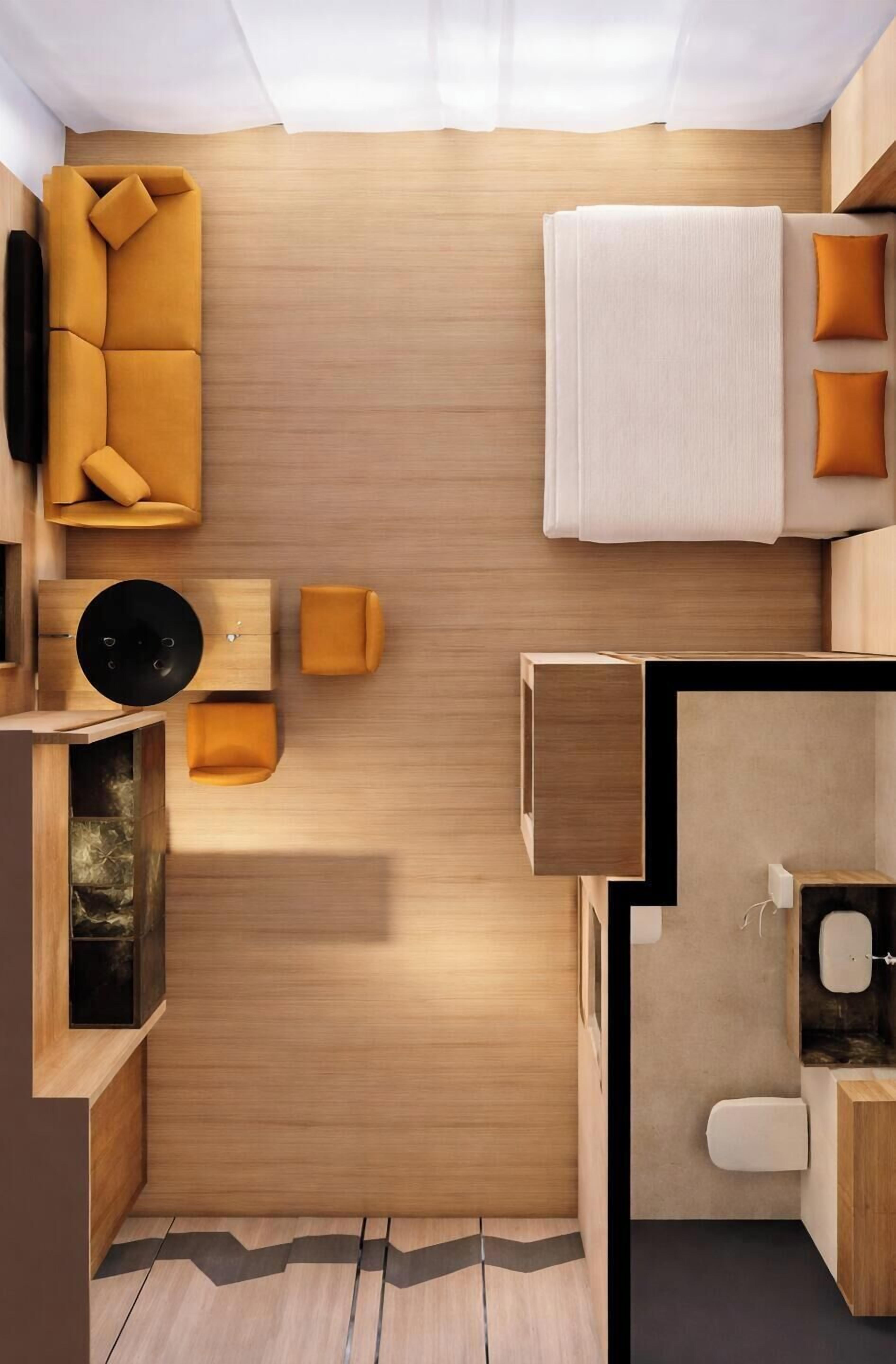 Een compacte, moderne badkamer met een houten wastafel, toilet en wastafel.