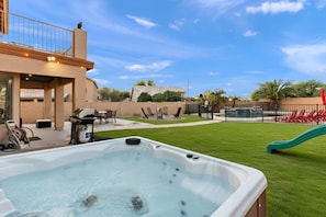 A backyard with a hot tub, outdoor furniture, a slide, and a pool. - Pause & Play | Pool, Spa, Gaming, Firepit & More (Casa Grande)