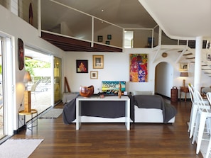 A modern living room with a sofa, a coffee table, and a sign reading 'ROOFTOP LOUNGE'. - Villa Azura | On the edge of the lagoon and beach, with a view of Moorea (Paea)