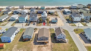 A coastal residential area with houses, a beach, and a clear view of the ocean. - Spread'n Kindness (Holly Ridge)