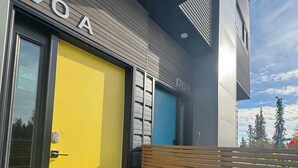 A modern building with a yellow door labeled '170 A' and a blue door labeled '170 B'.