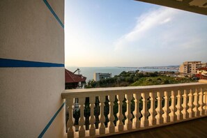A balcony with a view of a coastal cityscape, including buildings and greenery. - Tonis Rooms Vlore (Vlore)