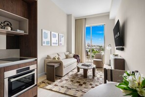 A modern living room with a sofa, coffee table, and a view of the city. - Modern 1BR Condo at Domus Brickell (Miami)