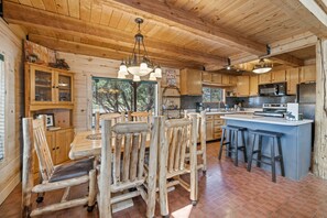 A rustic wooden interior with a dining area, kitchen, and bar. - Mountain Soul | ATV Access, Porch & Mountain Views (South Fork)
