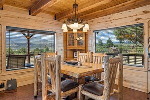 A wooden interior with a dining table, chairs, and a cabinet. - Mountain Soul | ATV Access, Porch & Mountain Views (South Fork)