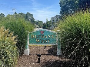 A sign for 'Bethany West' with a star emblem, surrounded by greenery. - Spacious Coastal Home Near Bethany Beach (Bethany Beach)