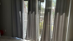 A bedroom with a large window, a bed, and a carpeted floor. - Exquisite gated private townhouse in the beautiful Palm Bay (Palm Bay)