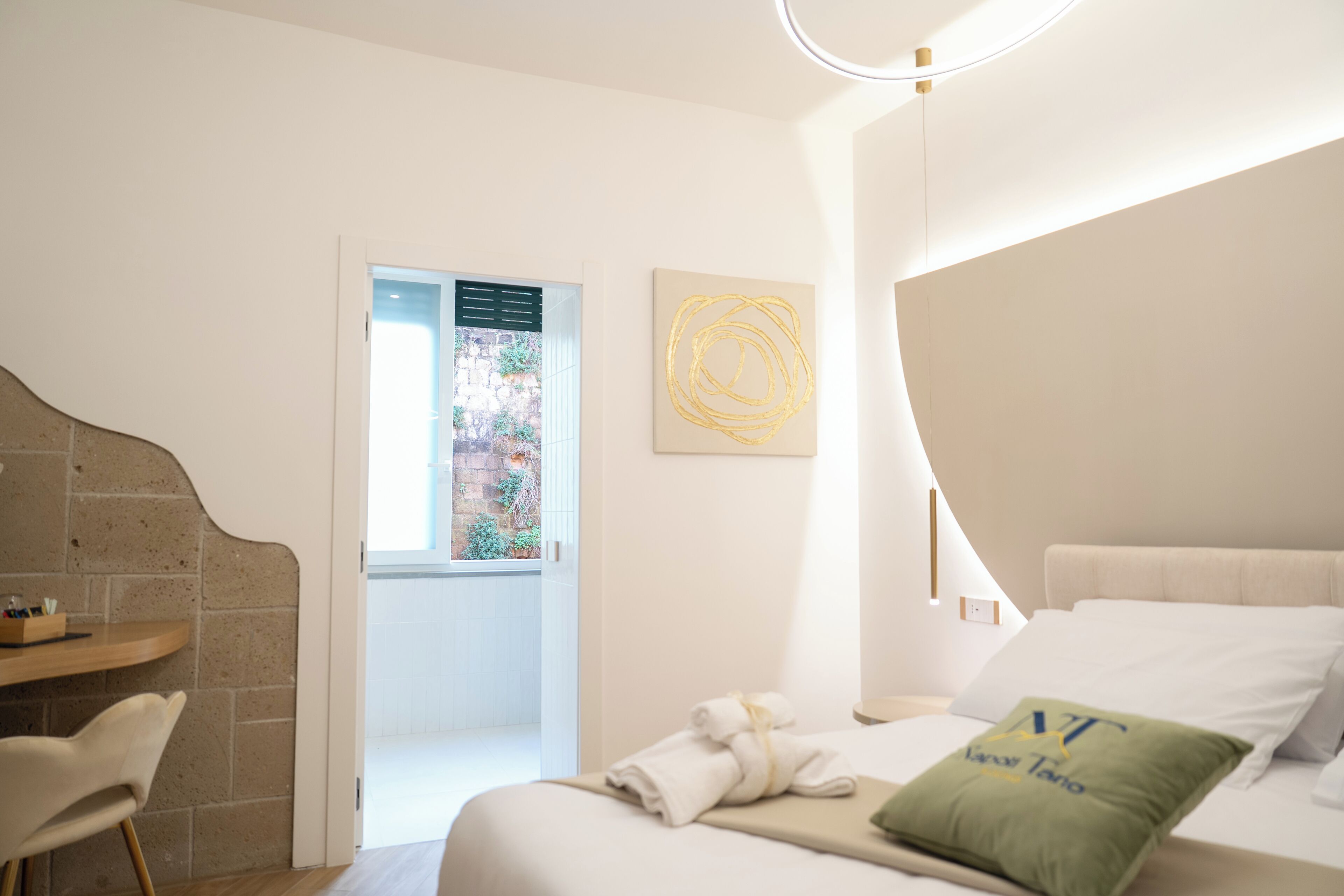 Habitació d'hotel moderna amb llit, escriptori i vistes a l'exterior.