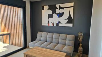 Suíte júnior, varanda coberta, vista parcial para o mar | Área de estar