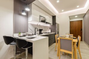 Fridge, microwave, stovetop, coffee/tea maker