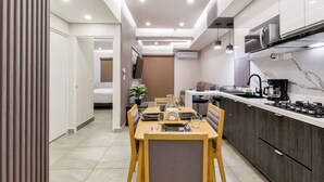 A modern kitchen with a dining area, a microwave, and a coffee maker.