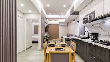 A modern kitchen with a dining area, a microwave, and a coffee maker.
