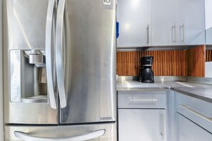 A stainless steel refrigerator with a water dispenser, a coffee maker, and a wooden panel backsplash. - ¡New in Santa Lucía! 6 guests, GYM, Pool, Parking (Monterrey)