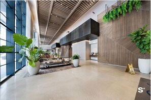 A modern lobby with a high ceiling, large windows, and potted plants. - Upscale 1BD Condo in Miami- City Views (Miami)
