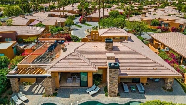 A residential area with multiple houses, a swimming pool, and mountains in the background. - Spacious 4bedroom villa in tranquil La Quinta, private gated lake community (La Quinta)