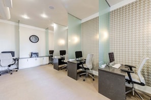 A modern office space with glass partitions, multiple workstations, and a clock on the wall. - Lake Carolyn Std Near Toyota MusicFactory Pool+GYM (Irving)