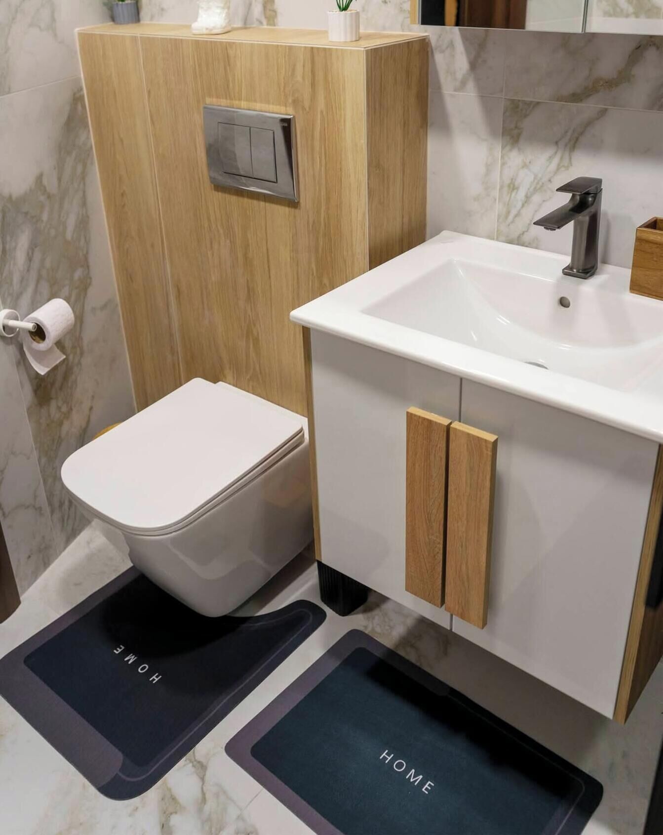 Ein Badezimmer mit Toilette, Waschbecken und einem Holzschrank.