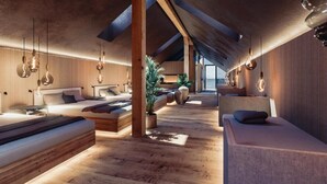 A modern interior with wooden floors, a sloped ceiling, and hanging pendant lights. - Vogl's Nest  (Fuschl am See)