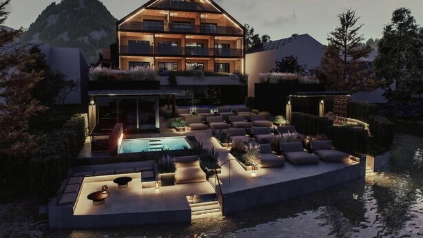 A modern multi-story house with a swimming pool, outdoor seating, and a mountainous backdrop. - Vogl's Nest  (Fuschl am See)