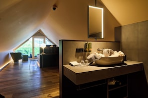 A modern bathroom with a large sink, towel rack, and a mirror. - Vogl's Nest  (Fuschl am See)